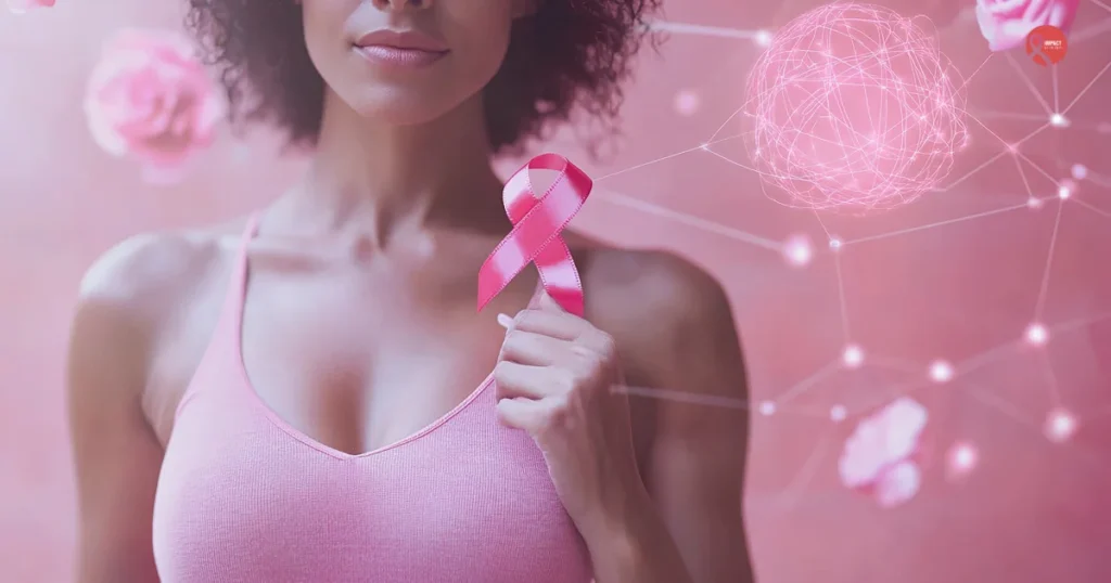 Woman wearing a pink top holding a pink breast cancer awareness ribbon against a soft pink background
