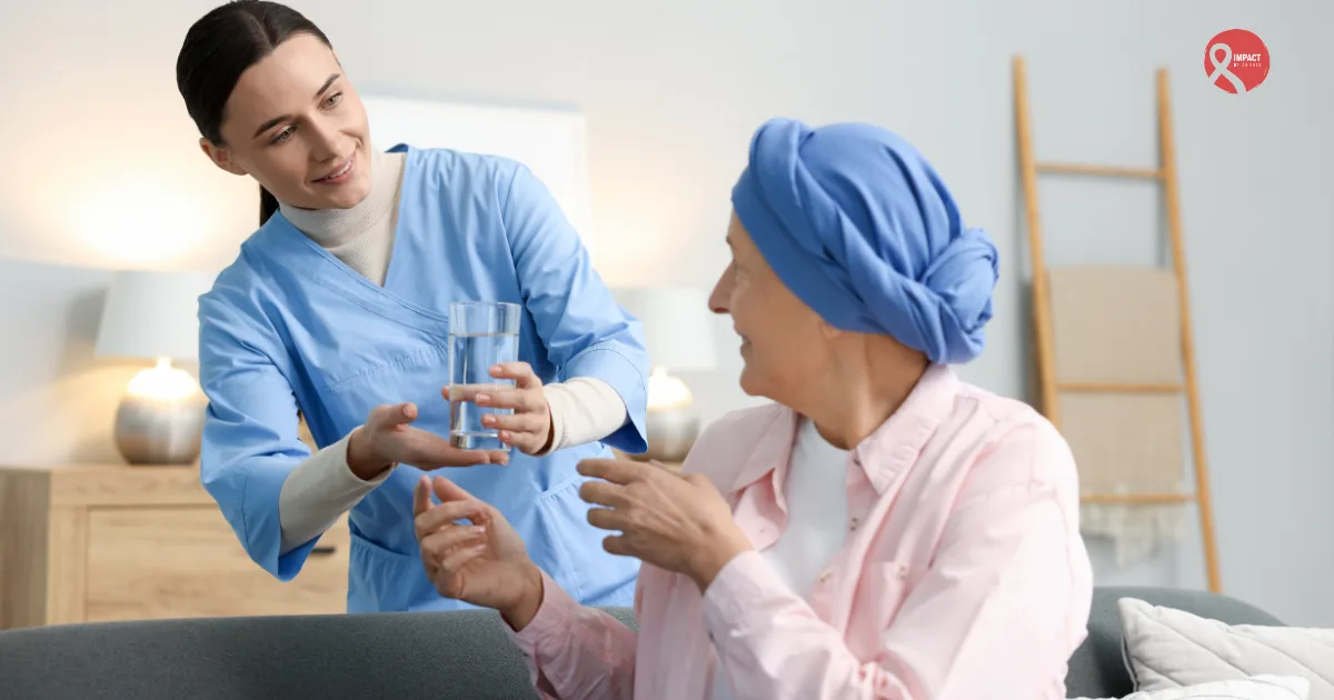 Nurse offering a glass of water to a cancer patient wearing a blue headscarf, symbolizing care, compassion, and emotional support during treatment.