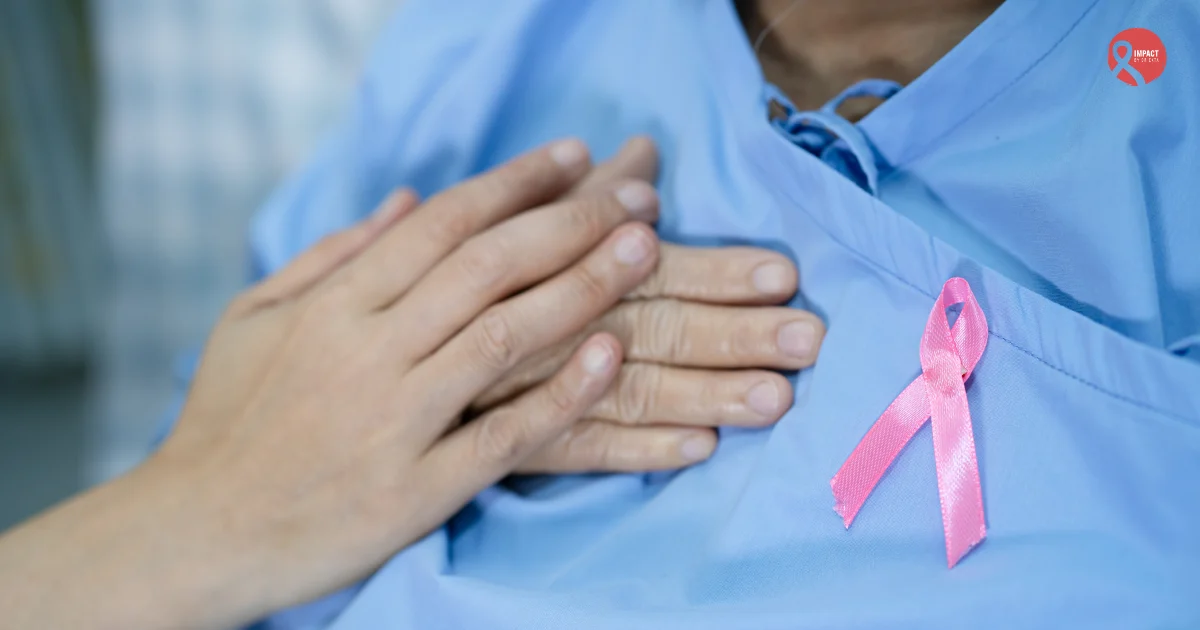 Close-up of a breast cancer patient with a pink ribbon receiving support, symbolizing targeted therapy treatment