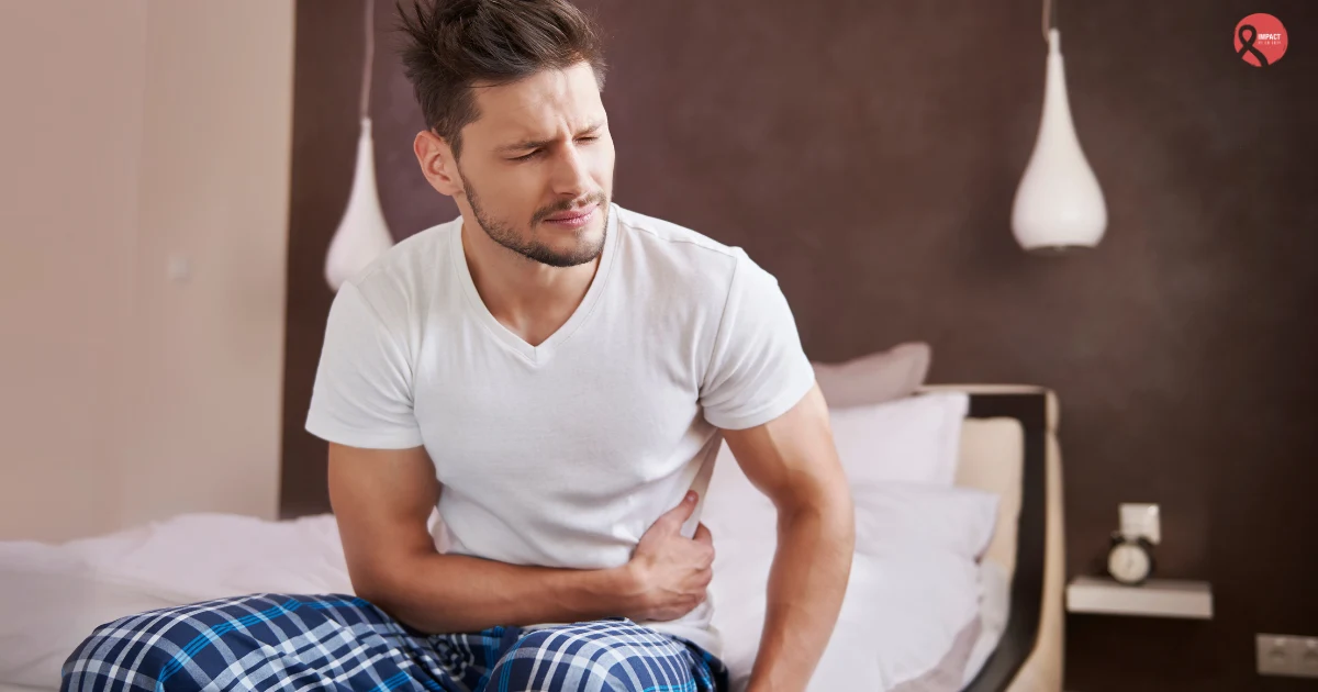 Young man holding stomach showing signs of difficult bowel movement.