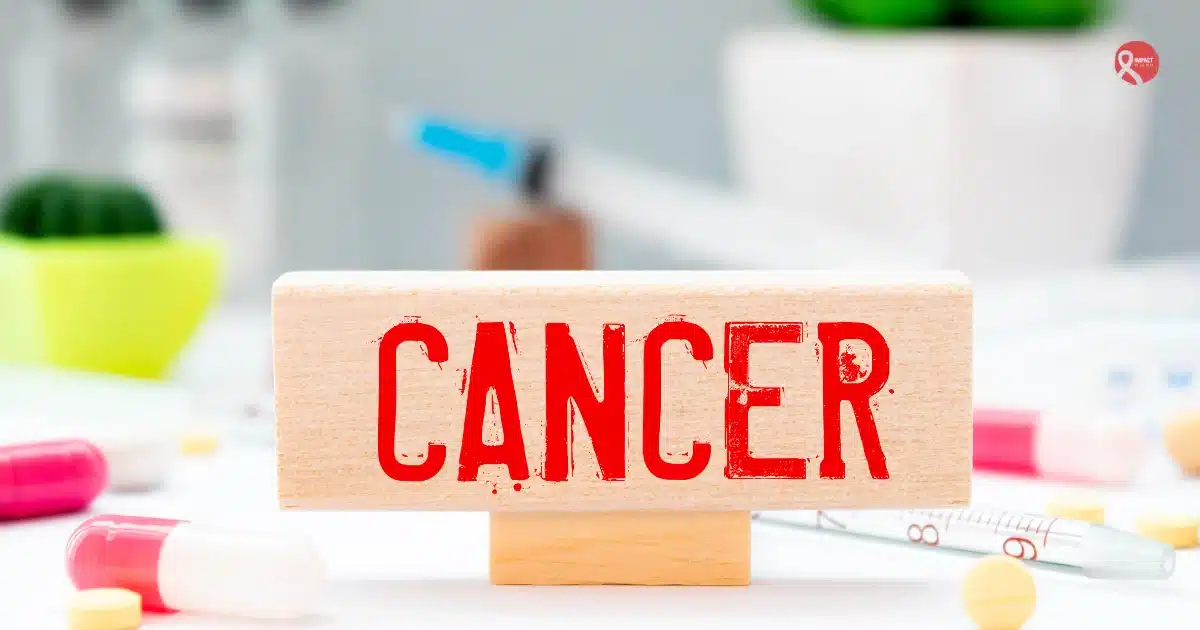 A wooden block labeled “Cancer” placed among medicines and medical tools, representing early-stage cancer diagnosis and treatment.