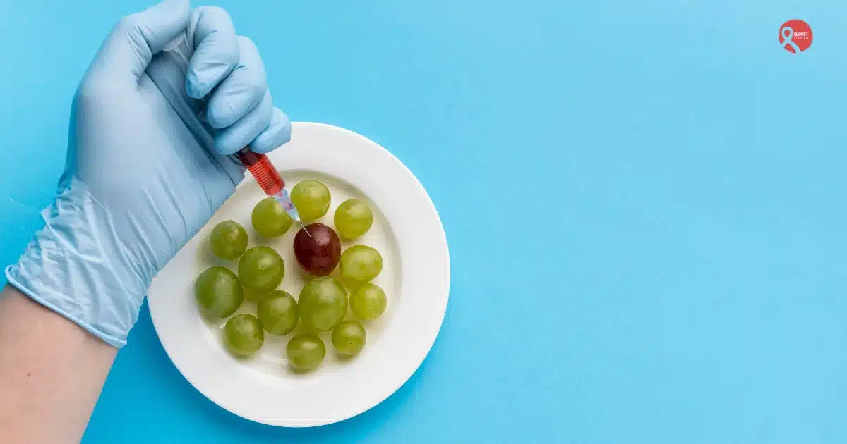 Gloved hand injecting a red grape with a syringe among green grapes, symbolizing food adulteration or chemical contamination in fruits.