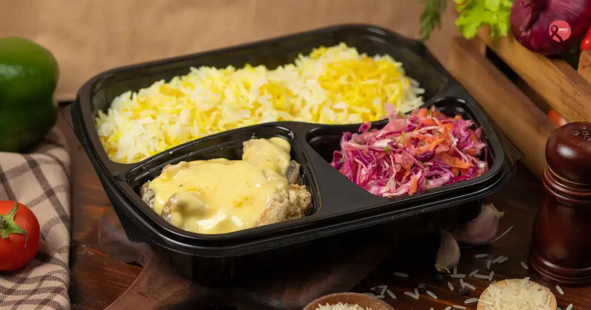 Microwavable plastic food container with rice and cooked meal used for reheating food