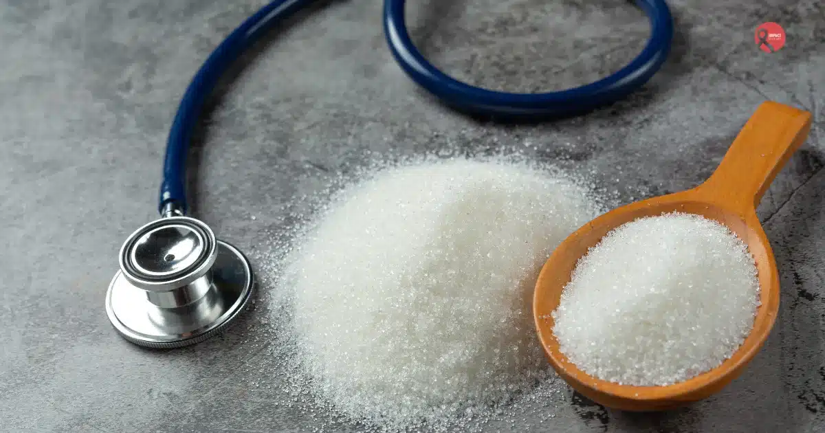 Sugar placed beside a stethoscope, representing the link between sugar consumption and health concerns like cancer.